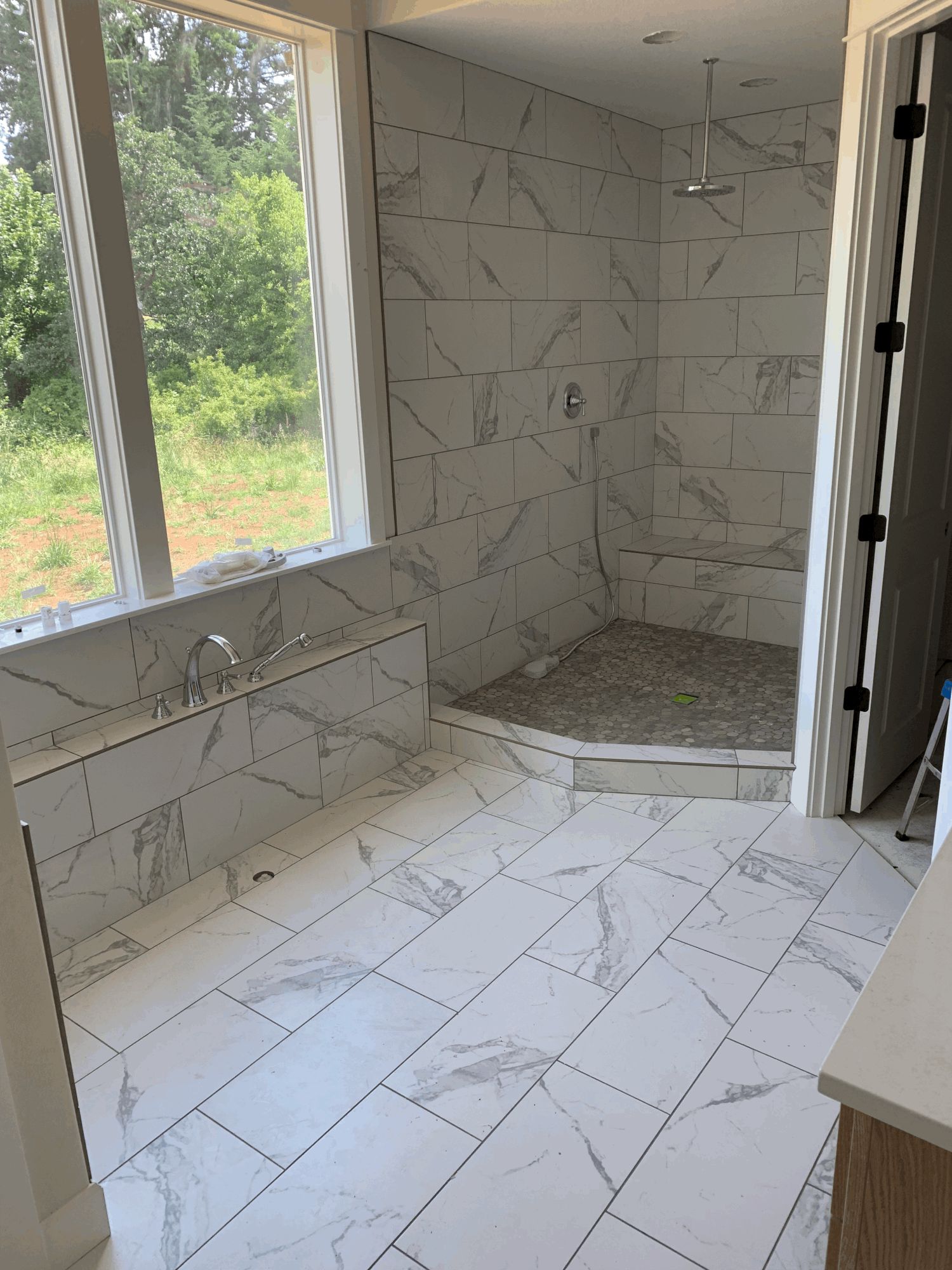 A bathroom with a walk in shower and a bathtub.
