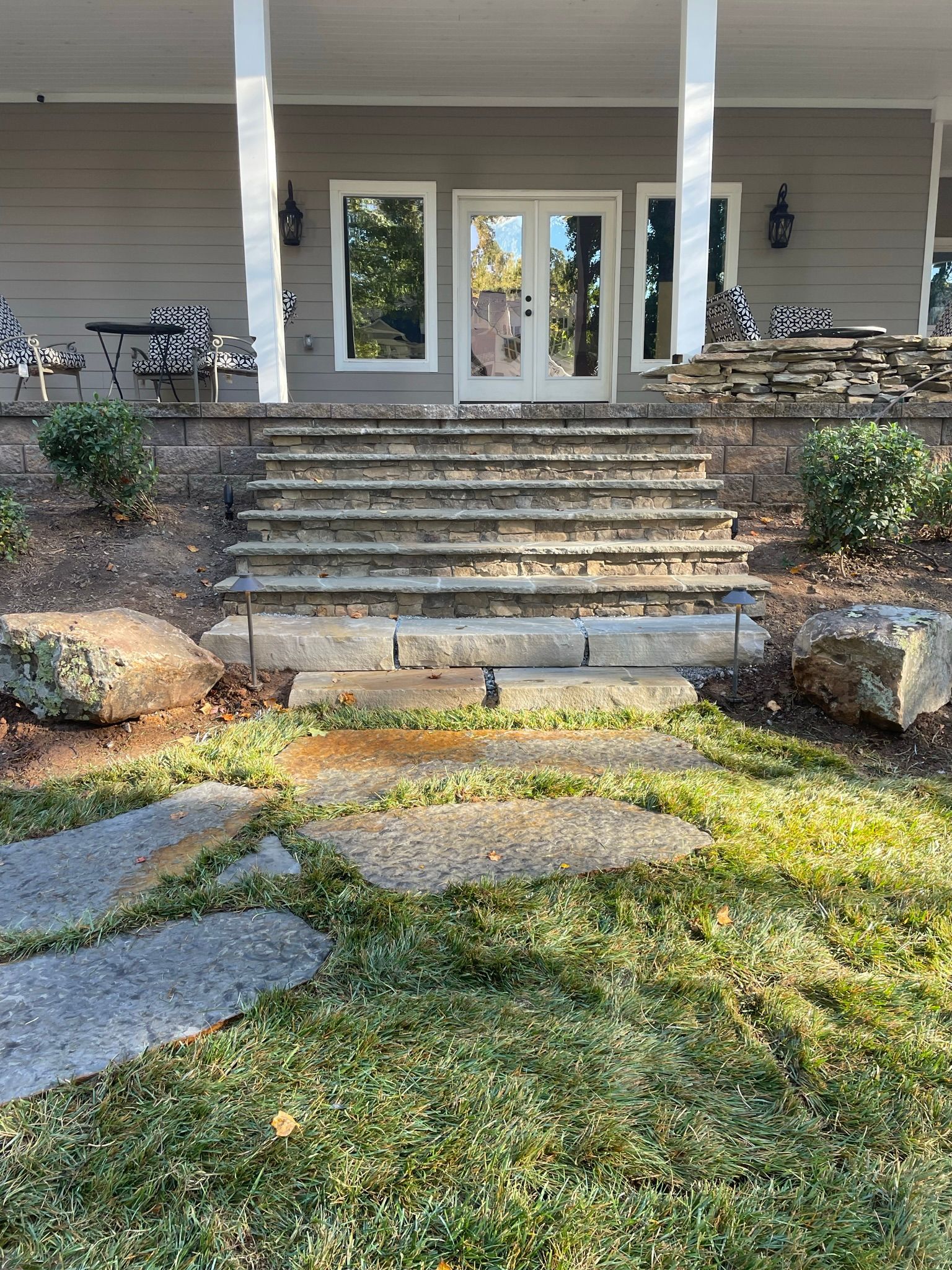 A house with a porch and stairs leading up to it.