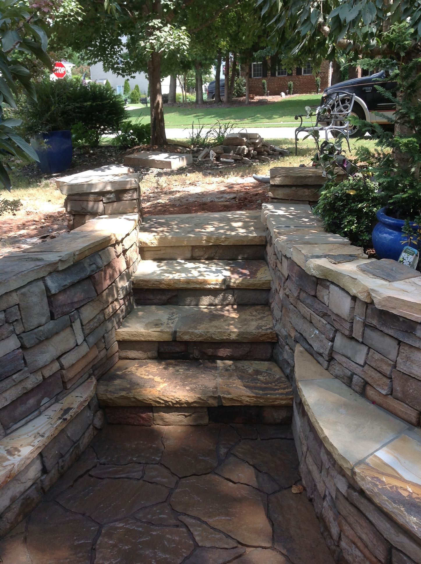 A stone walkway with stairs leading up to a house