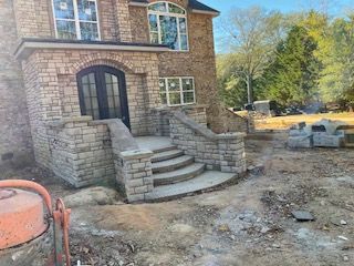 A brick house with stairs leading up to it is being built.