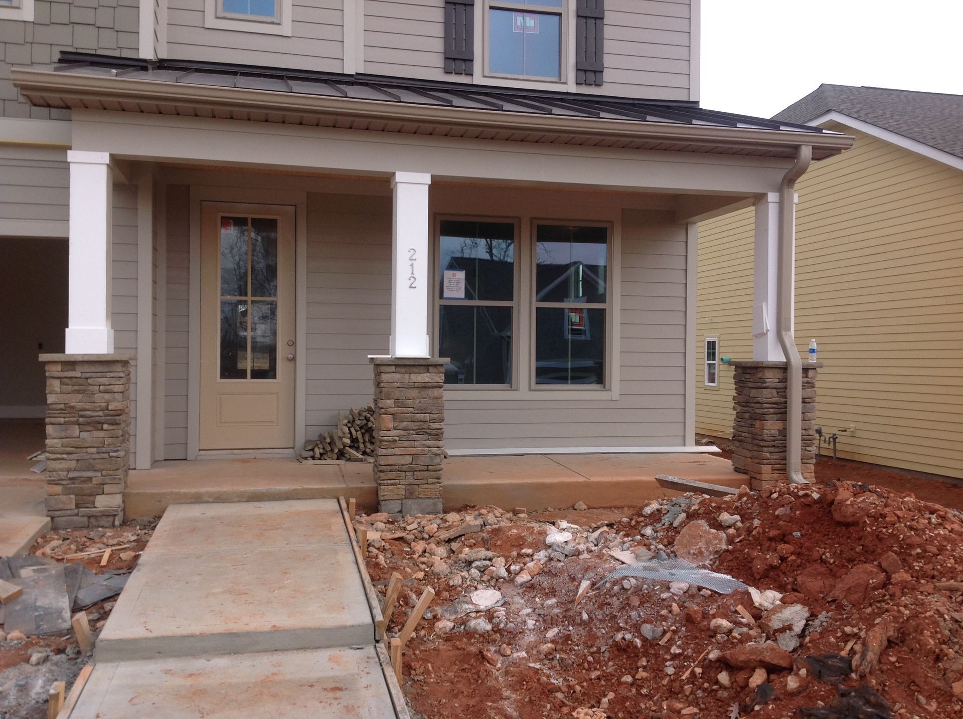 The front porch of a house that is under construction