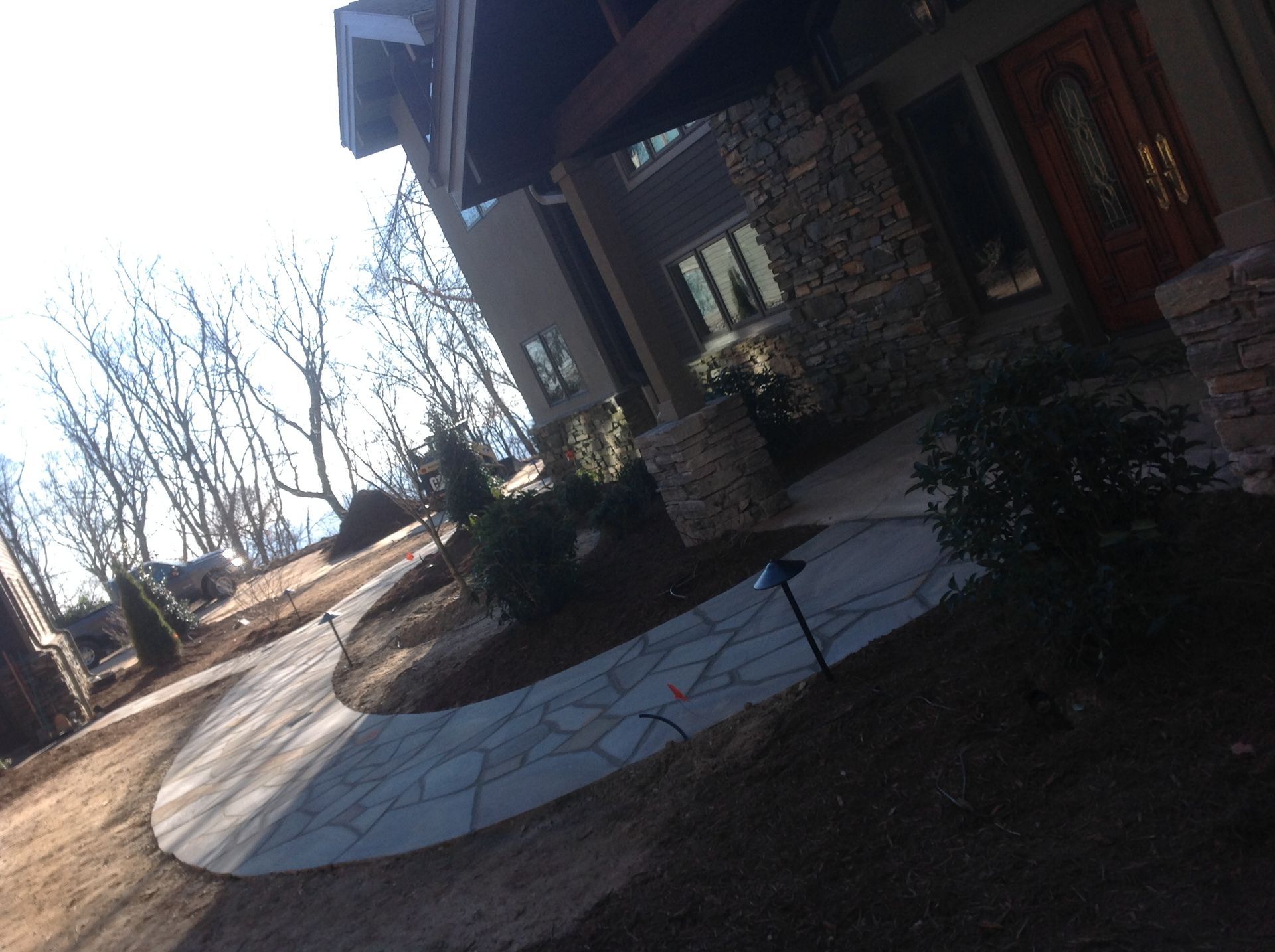 A stone house with a walkway leading to it