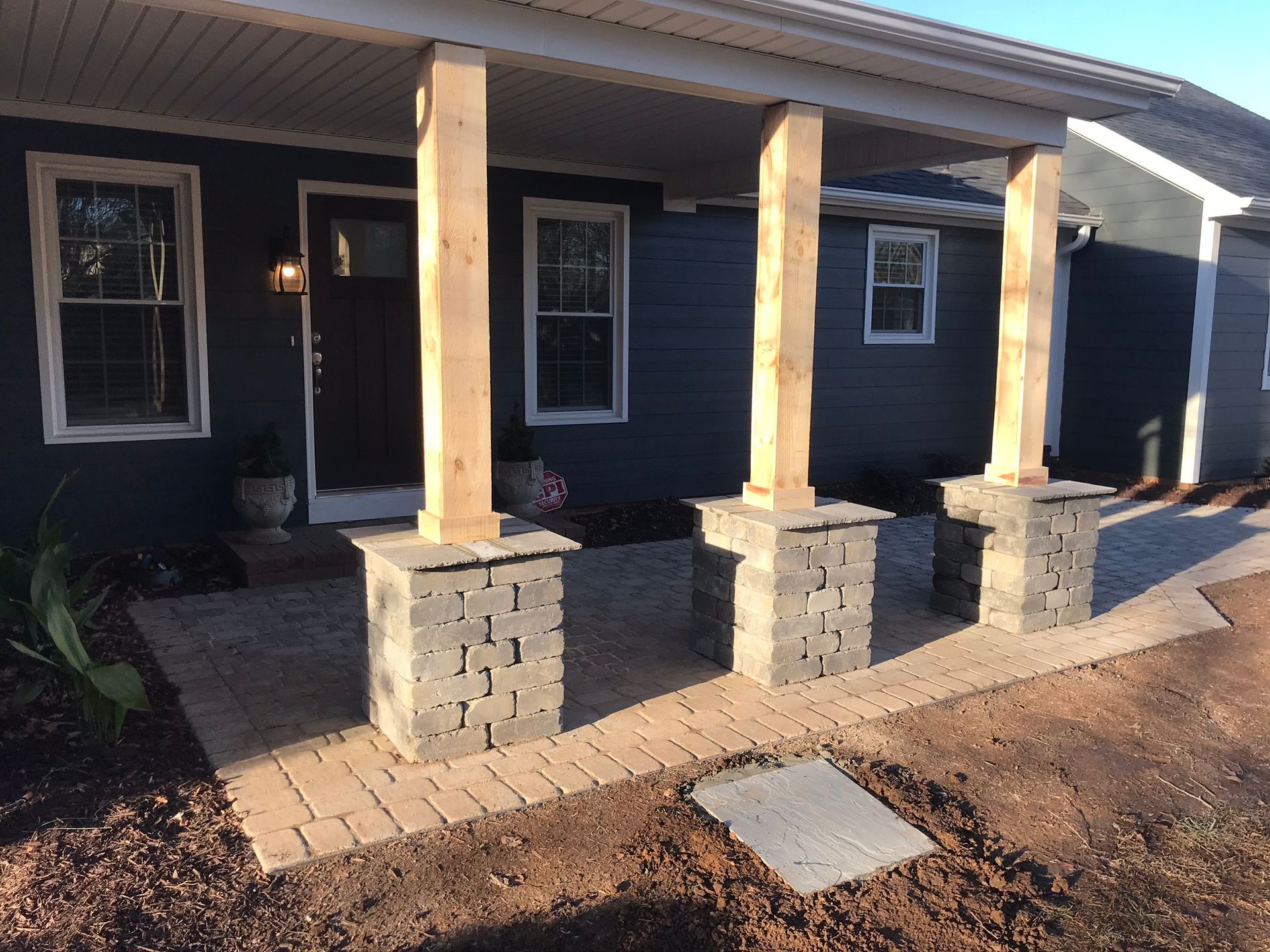 A house with a porch and pillars in front of it