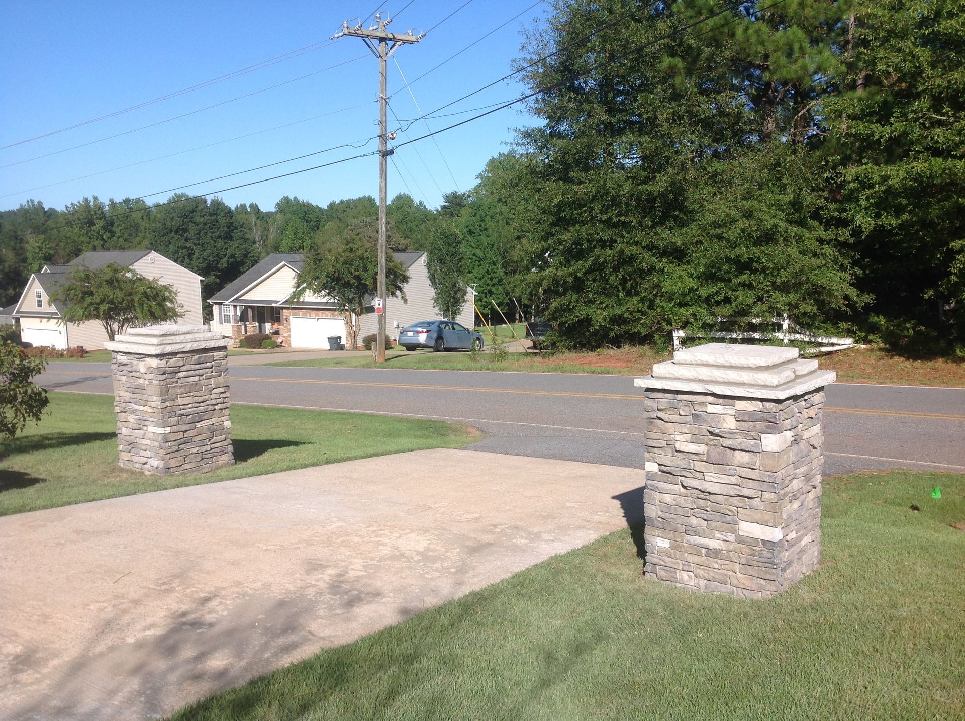 A couple of stone pillars in front of a house