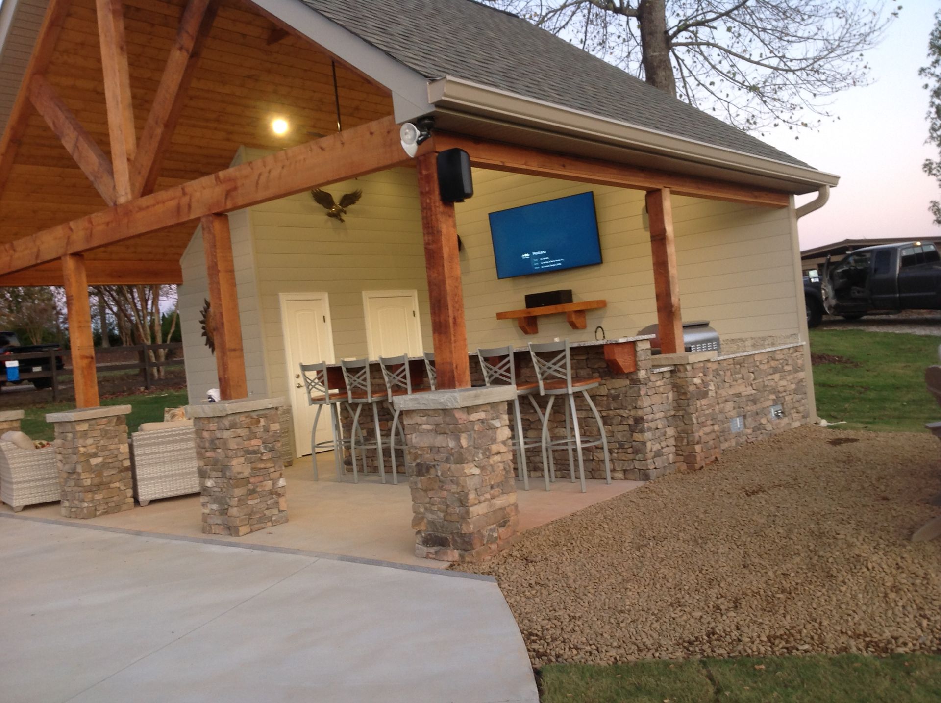 A house with a covered porch and a television on the wall