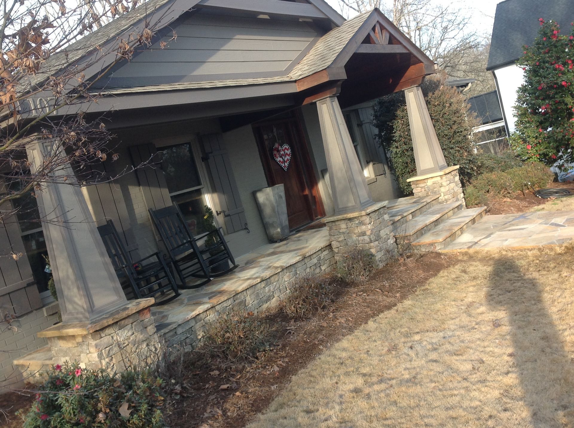 A house with a porch and rocking chairs on it