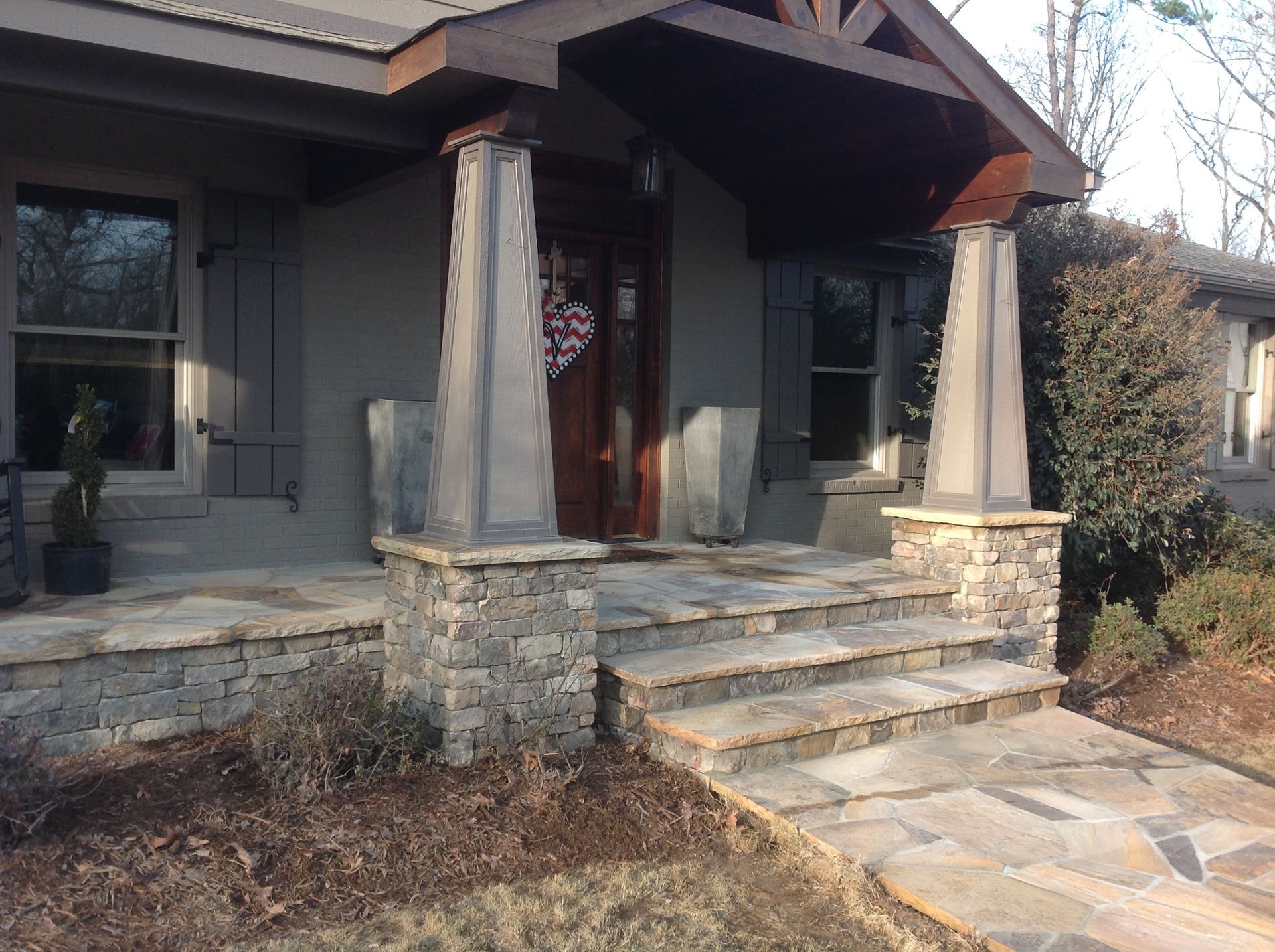 A house with a stone walkway leading to the front door