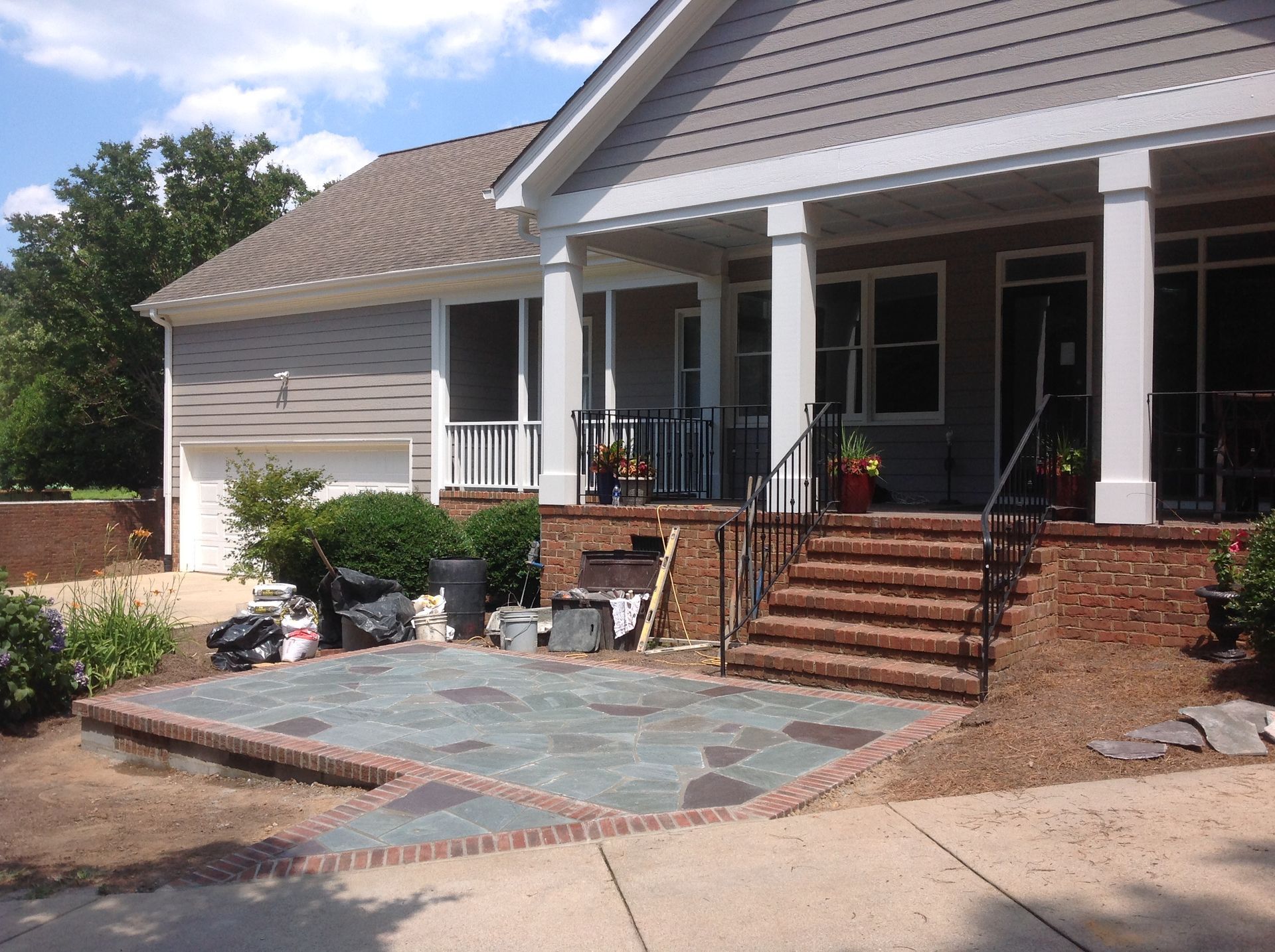 A house with a screened in porch and stairs
