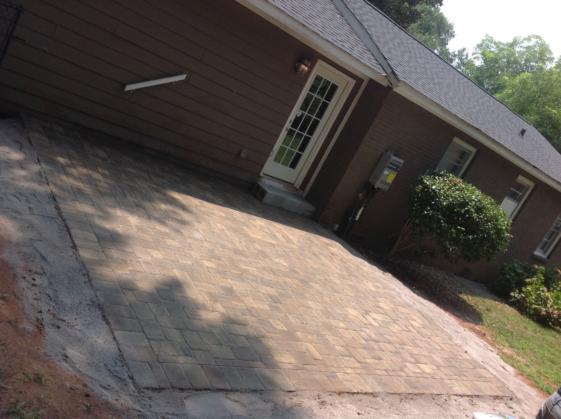 A house with a brick patio in front of it
