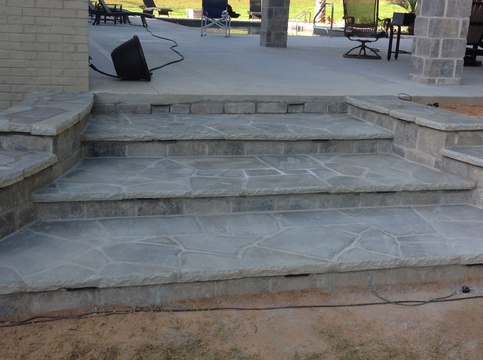 A set of stone steps leading up to a patio