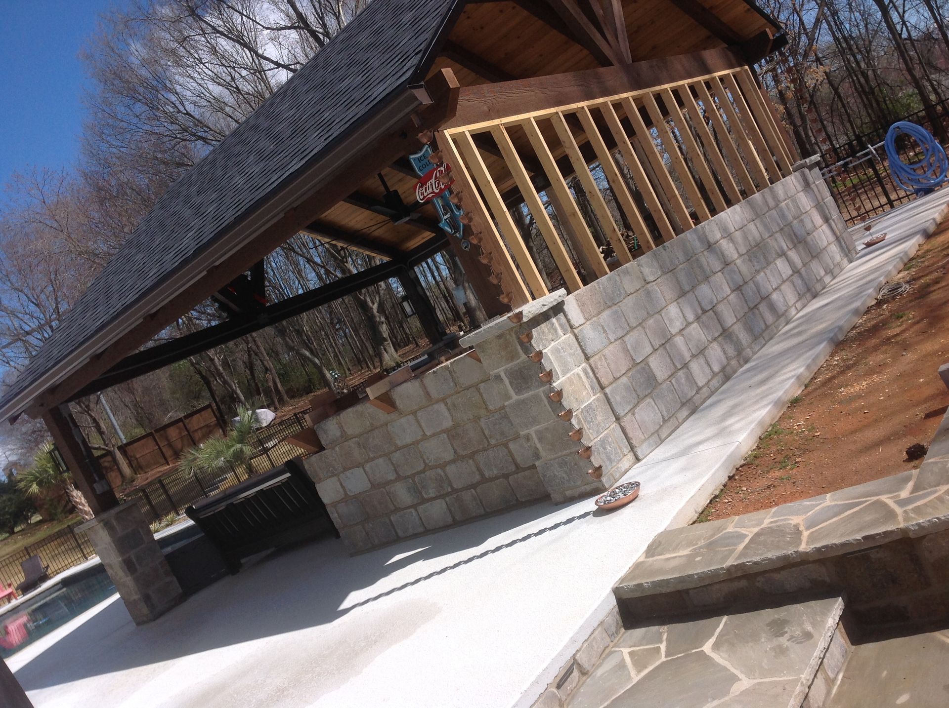 A pavilion is being built in the backyard of a house.