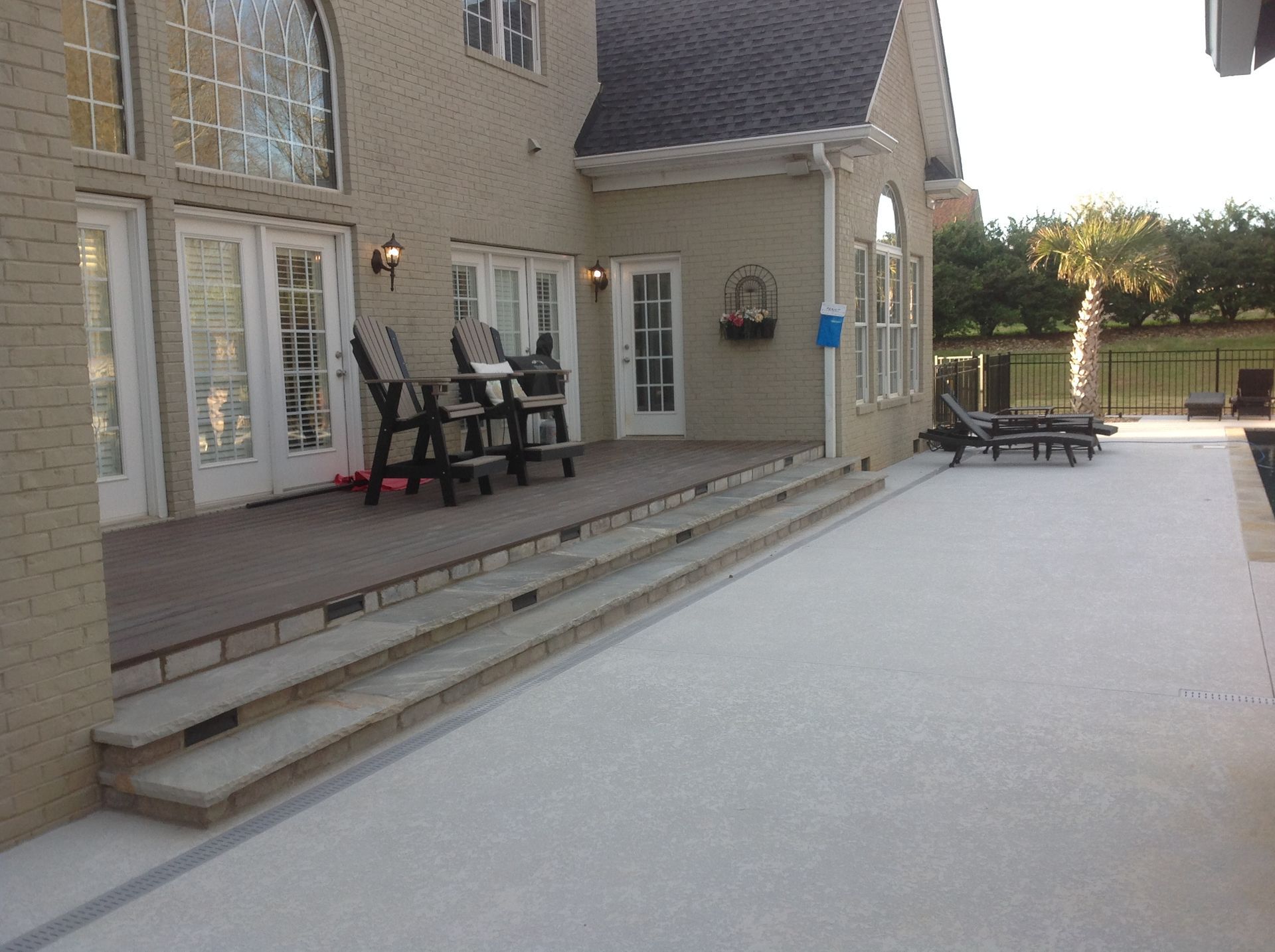A large house with a patio and chairs on it