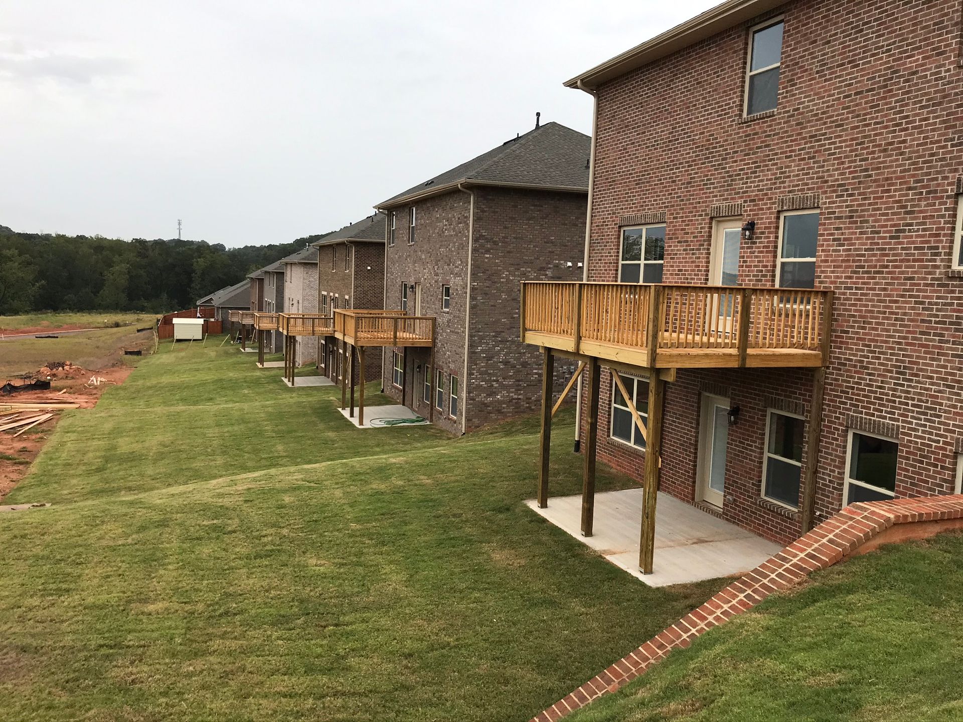 A row of brick houses with wooden decks in front of them