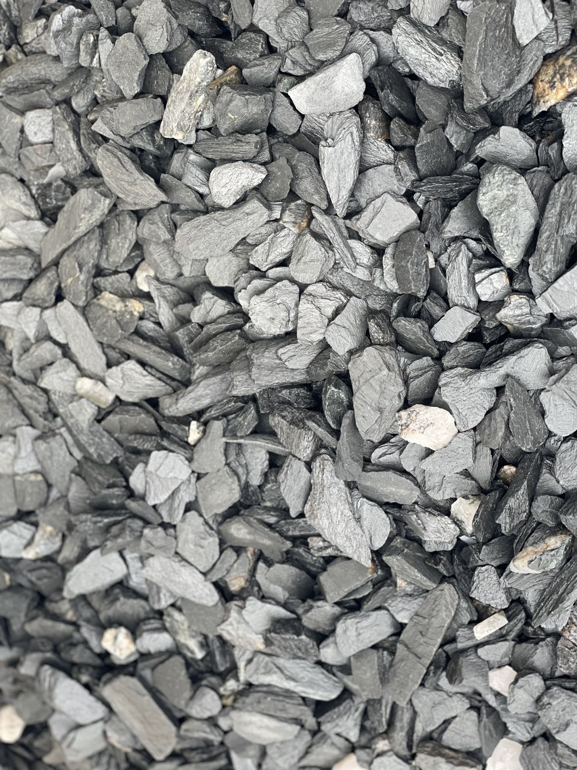 A pile of rocks sitting on top of each other on the ground.