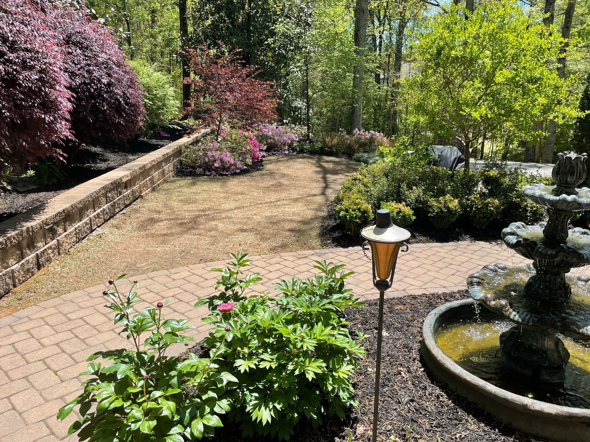 There is a fountain in the middle of the garden.