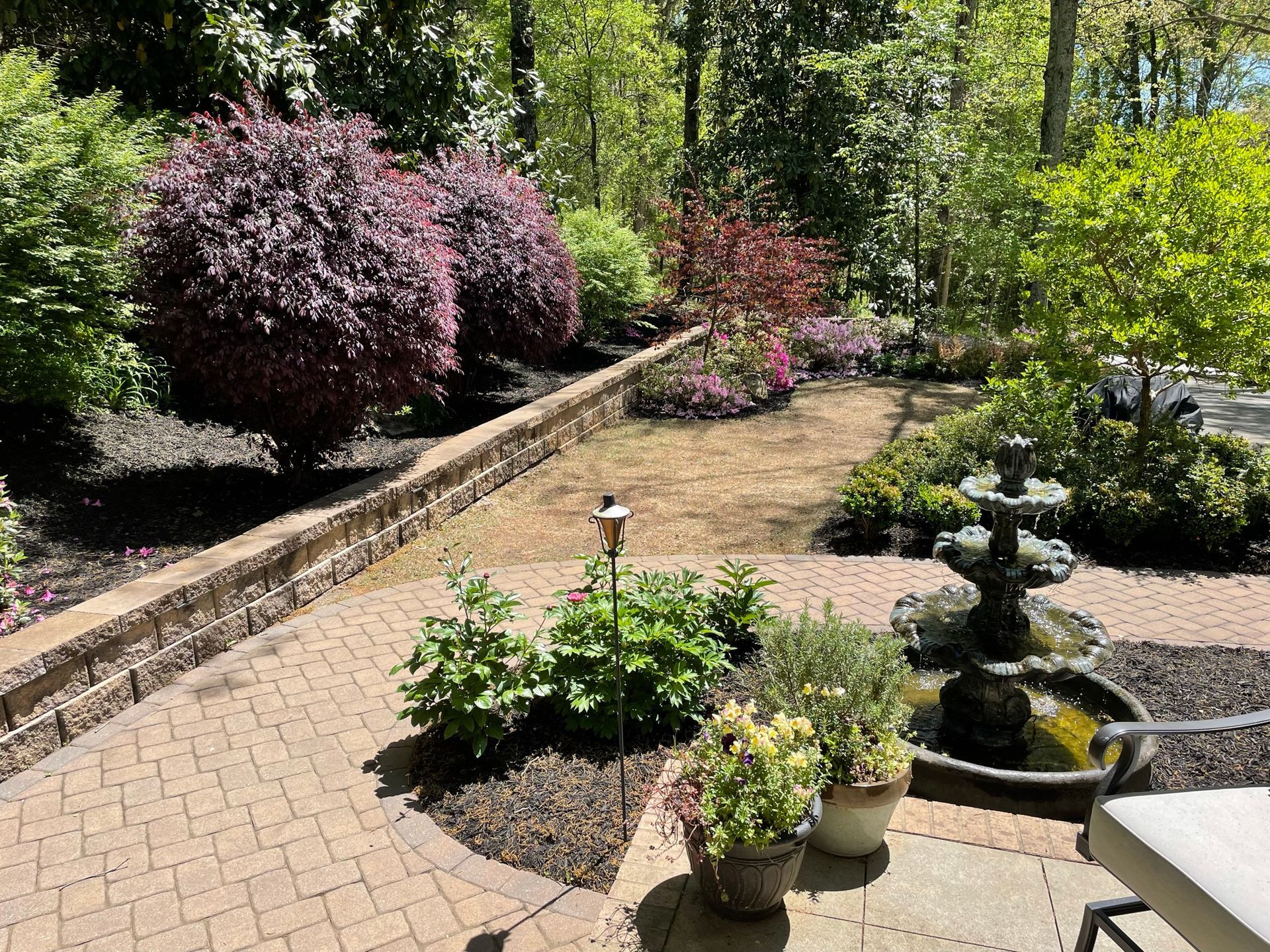There is a fountain in the middle of the garden.