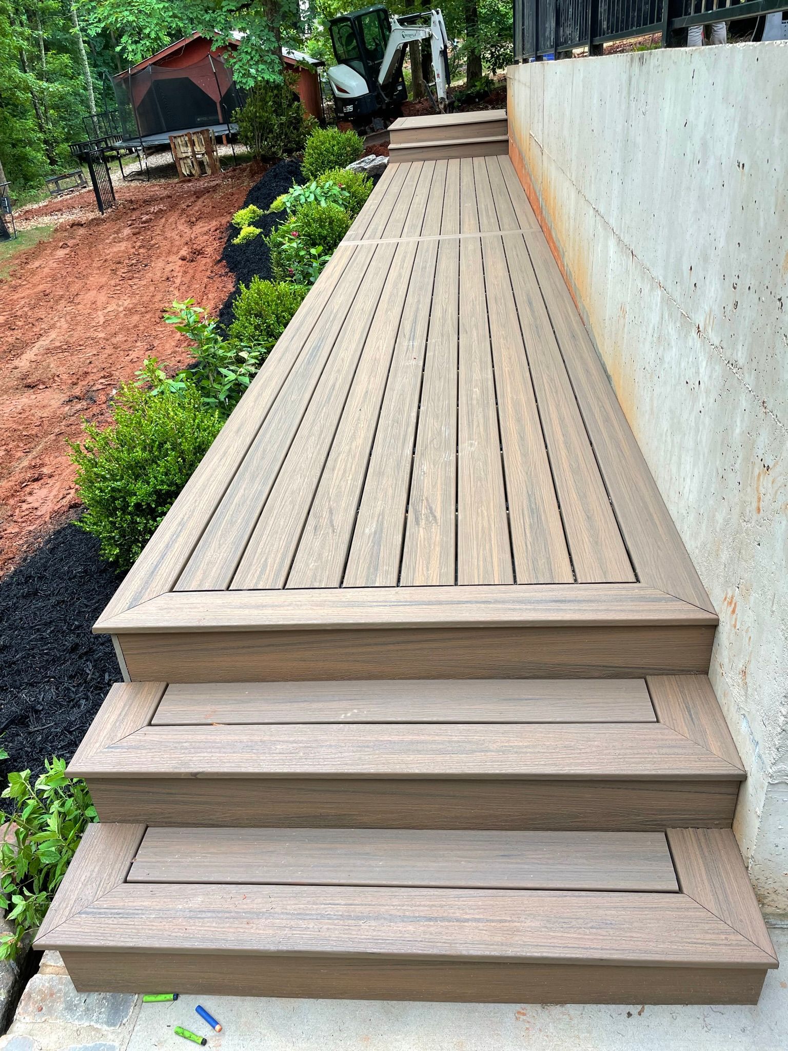 A wooden deck with stairs leading up to it.