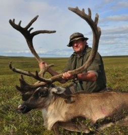 A man is riding a reindeer in a field