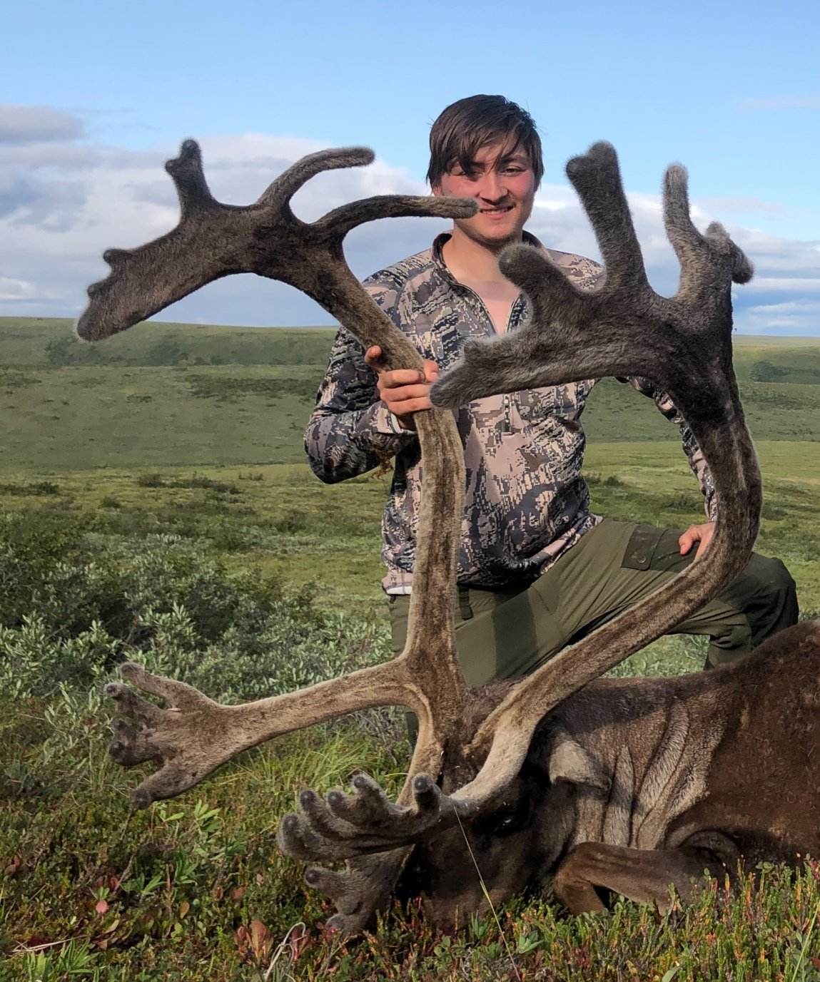 Happy Caribou Hunter with a nice barren ground caribou taken on a guided hunt