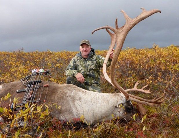 man with caribou harvested with a bow