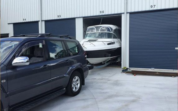 Vehicle Reversing Boat Into Storage Unit — Self Storage in Cooloola Cove QLD