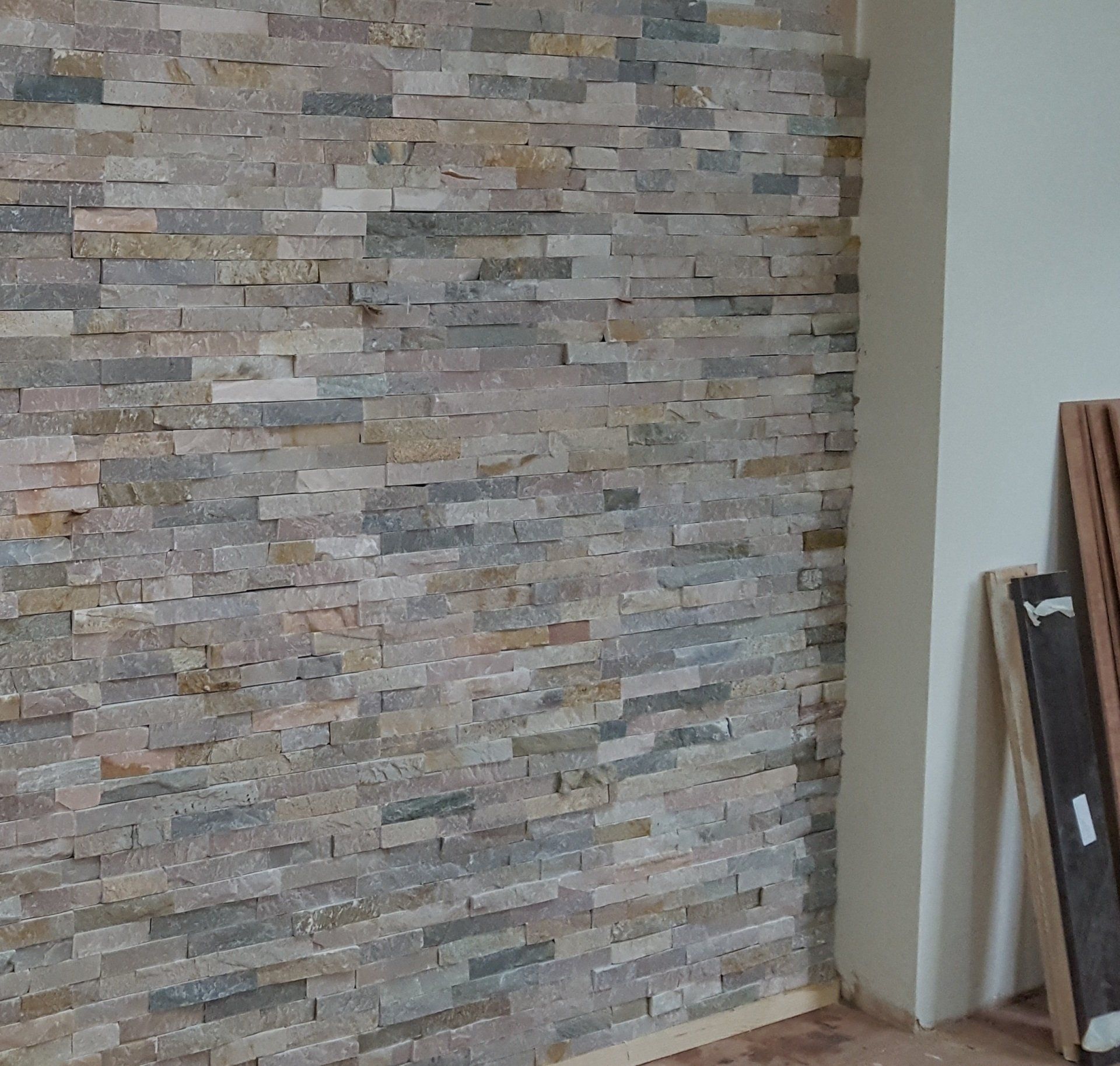 Zest Underfloor Heating Rotherham - fitted grey textured tiled feature wall in a living room