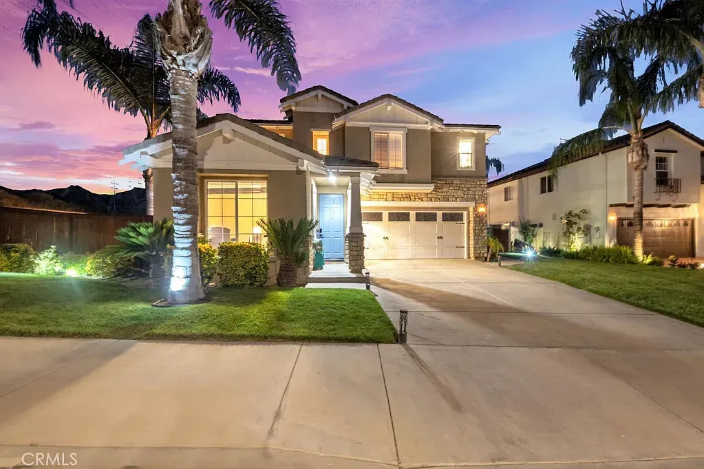 Spacious living room with blue sectional sofa, area rug, wooden floor, and a TV | Homes for Sale in Santa Clarita, CA
