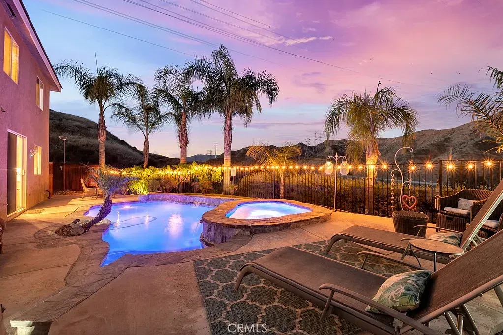 Elegant dining room with chandelier, set table, and open doorways to adjoining rooms | Best Realtor in Santa Clarita, CA