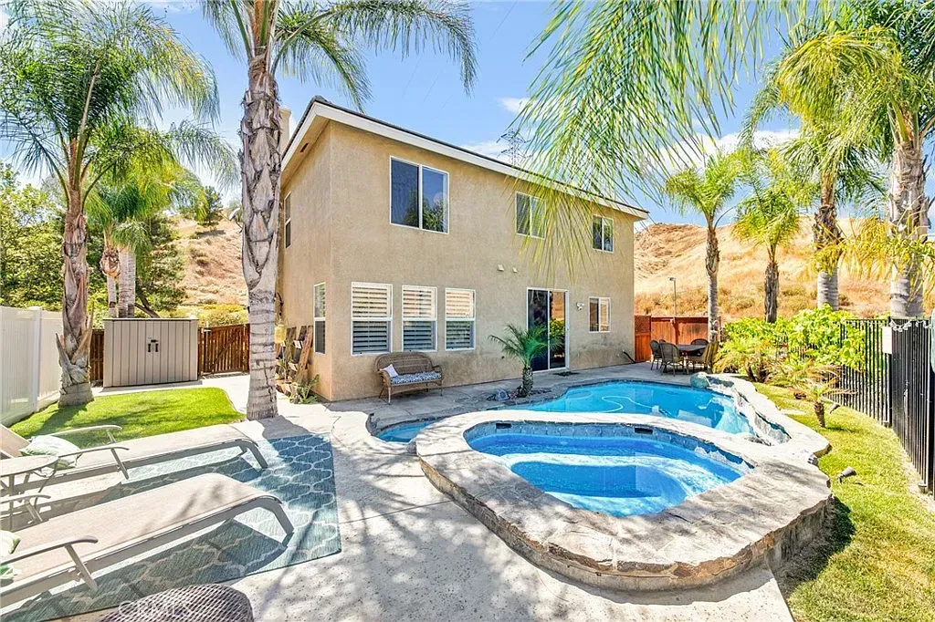 Spacious open-concept living area with sectional sofa, wood coffee table, and nearby kitchen | Realtor in Santa Clarita, CA
