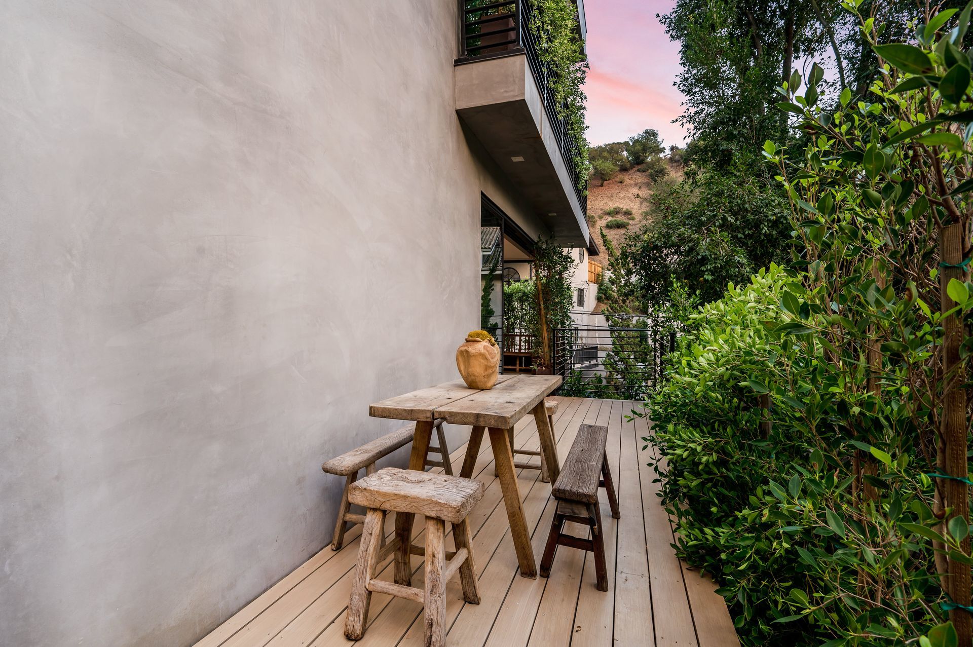 Spacious open-concept living area with sectional sofa, wood coffee table, and nearby kitchen | Realtor in Santa Clarita, CA