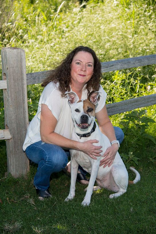 Carey sitting with her dog. 