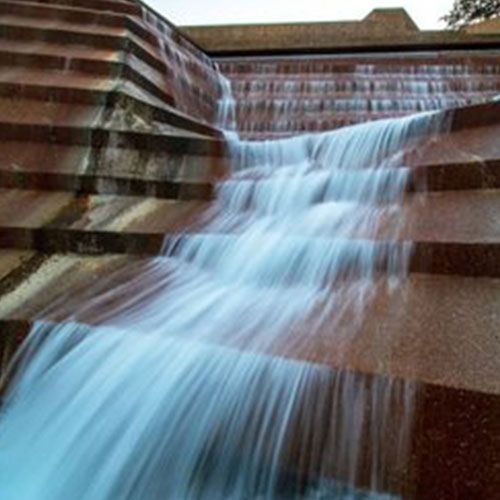 A waterfall is flowing down a set of stairs