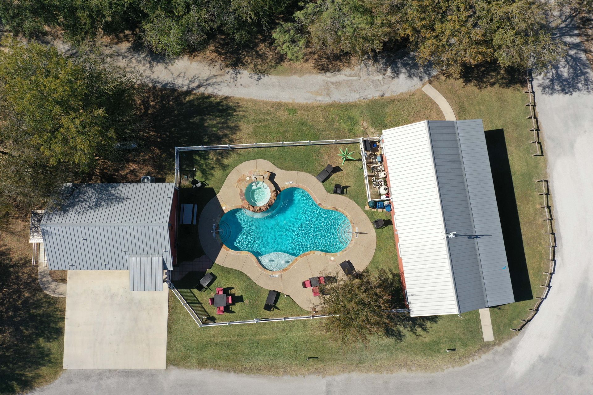 An aerial view of a house with a swimming pool