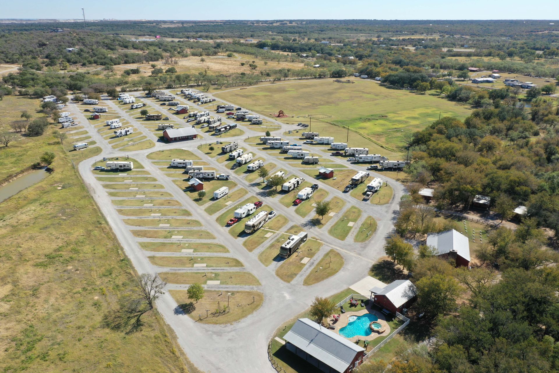 An aerial view of a campground with a swimming pool.