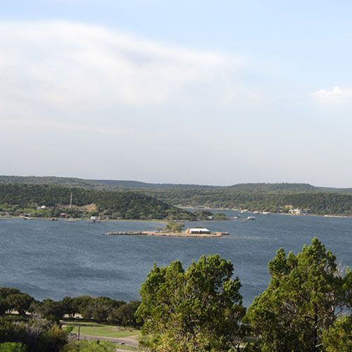 A large body of water with a small island in the middle
