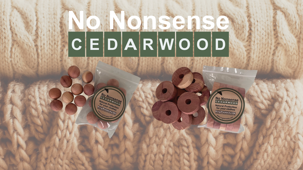 Picture of cedar wood balls and rings on a backdrop of a pile of woollen jumpers.