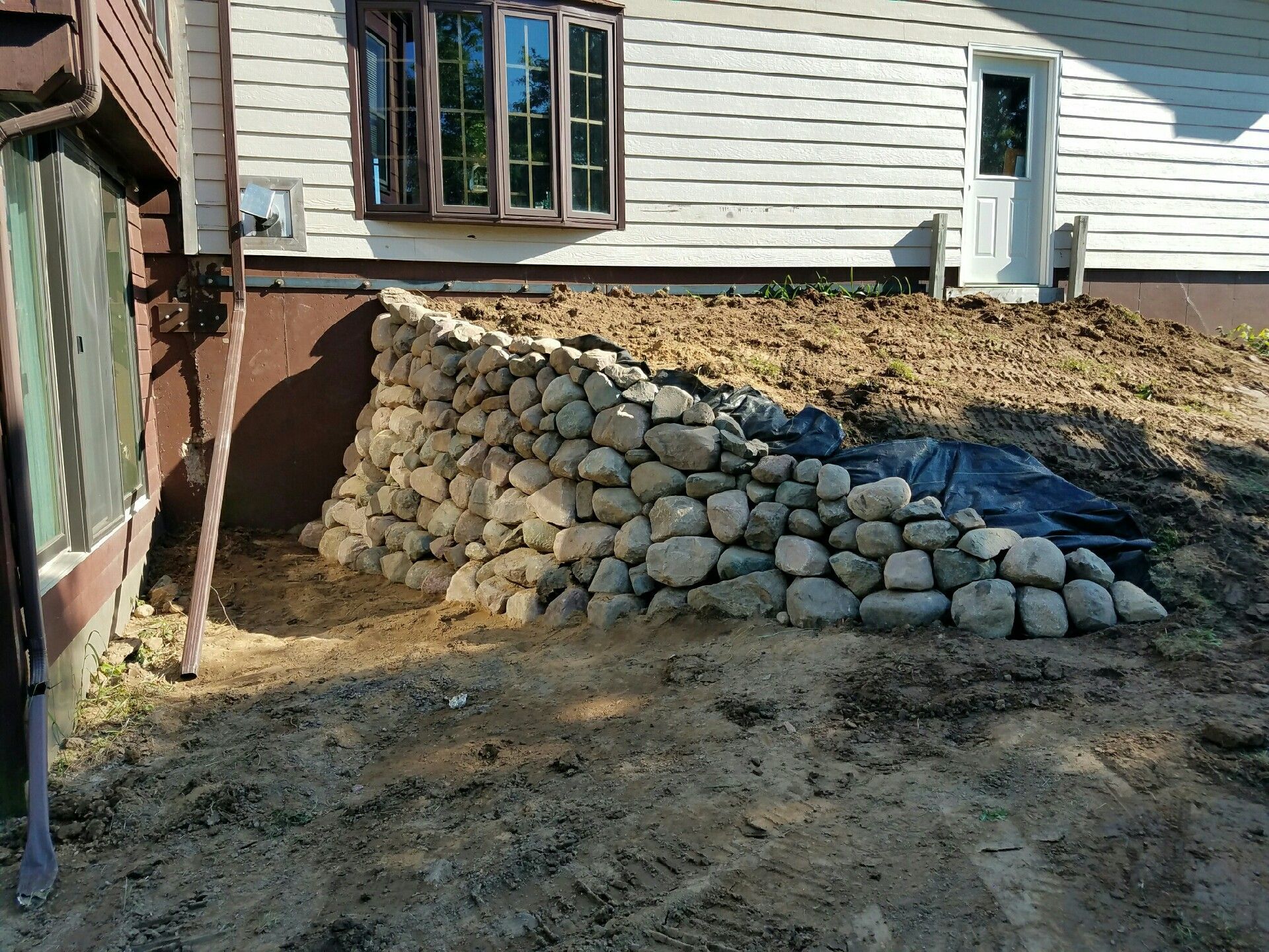 Aerial view of a winding river flowing through a dense, green forest.