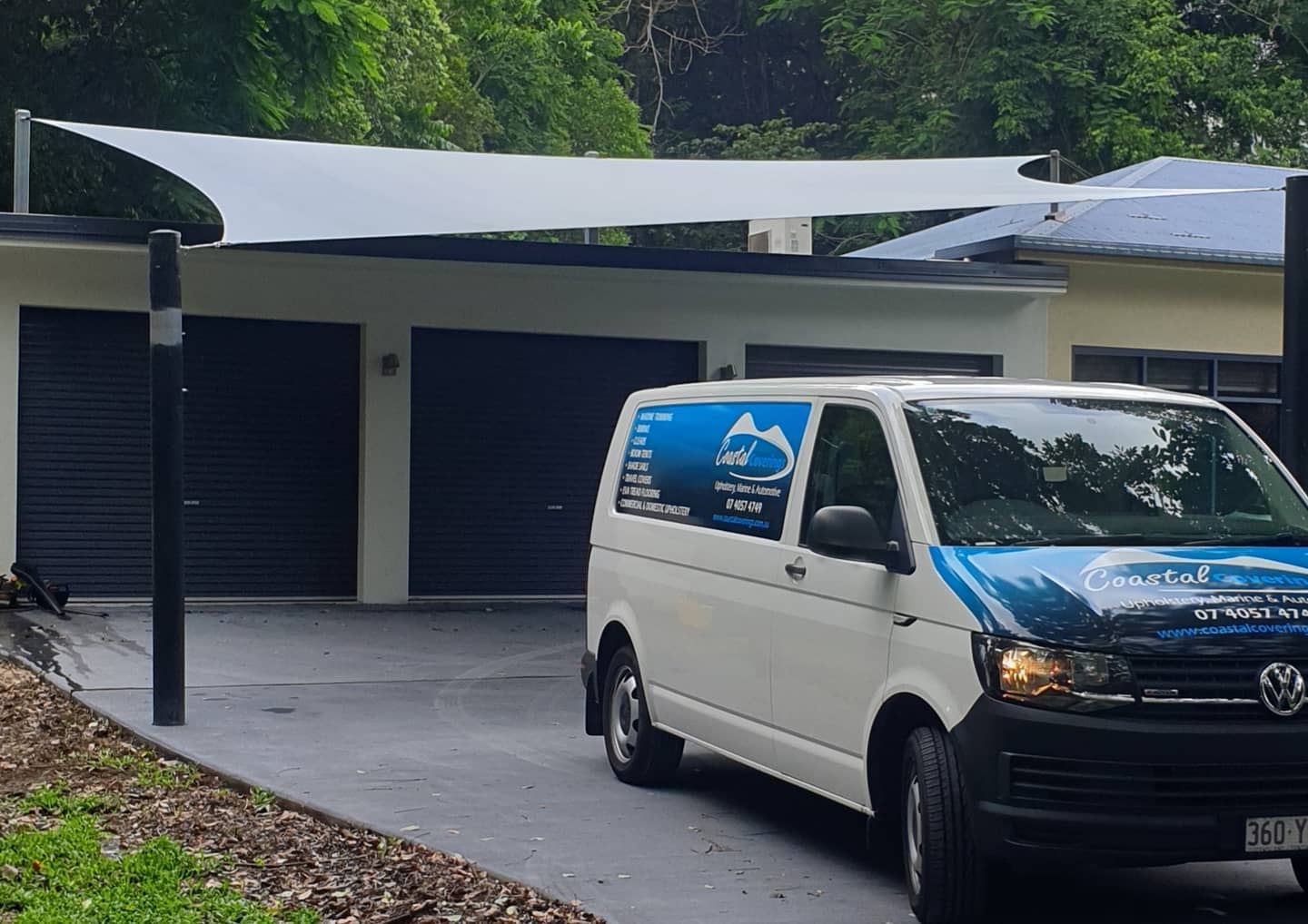 A Blue and White Van is Parked in Front of a House — Coastal Coverings In Smithfield, QLD