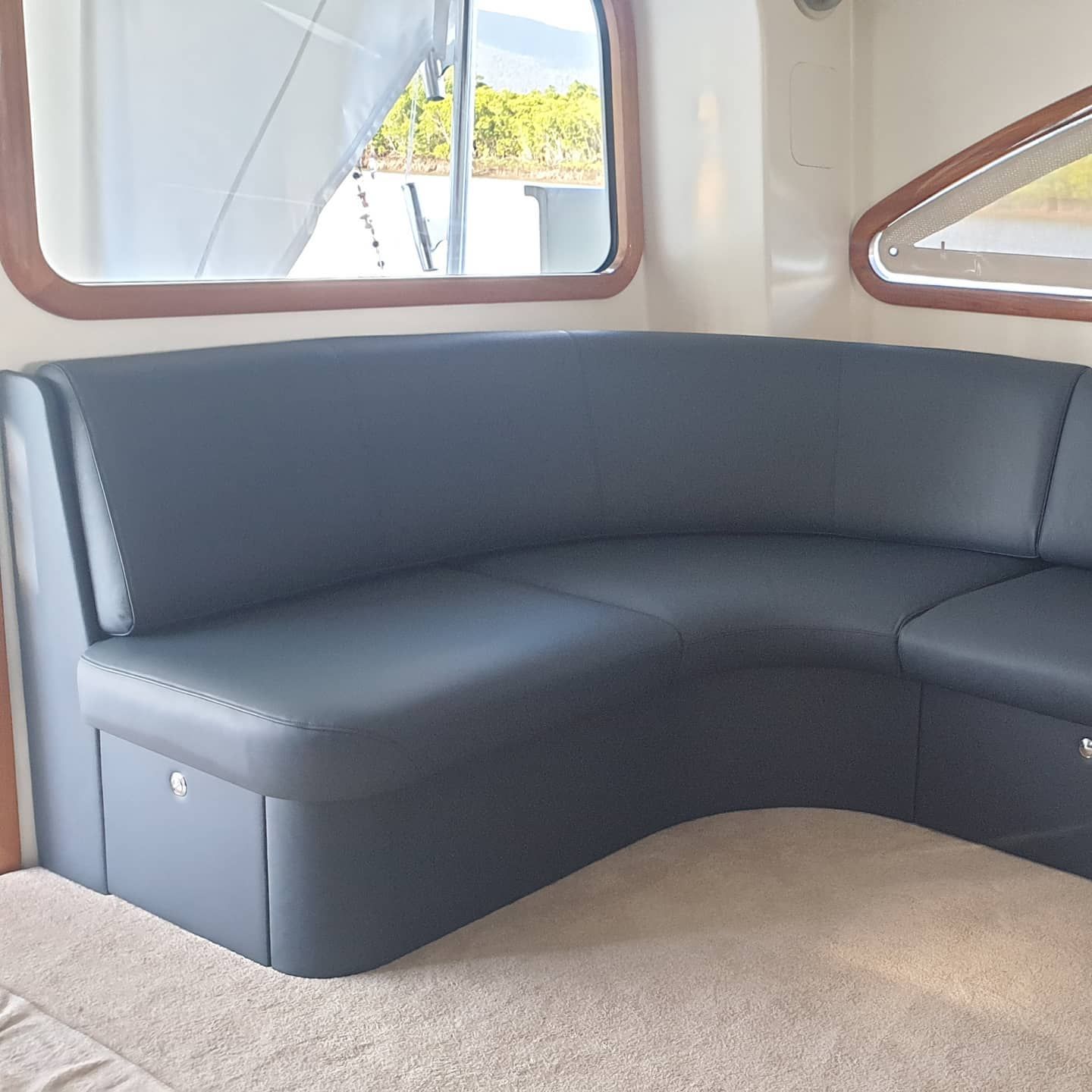 A Black Leather Couch in a Room With a Window — Coastal Coverings In Smithfield, QLD
