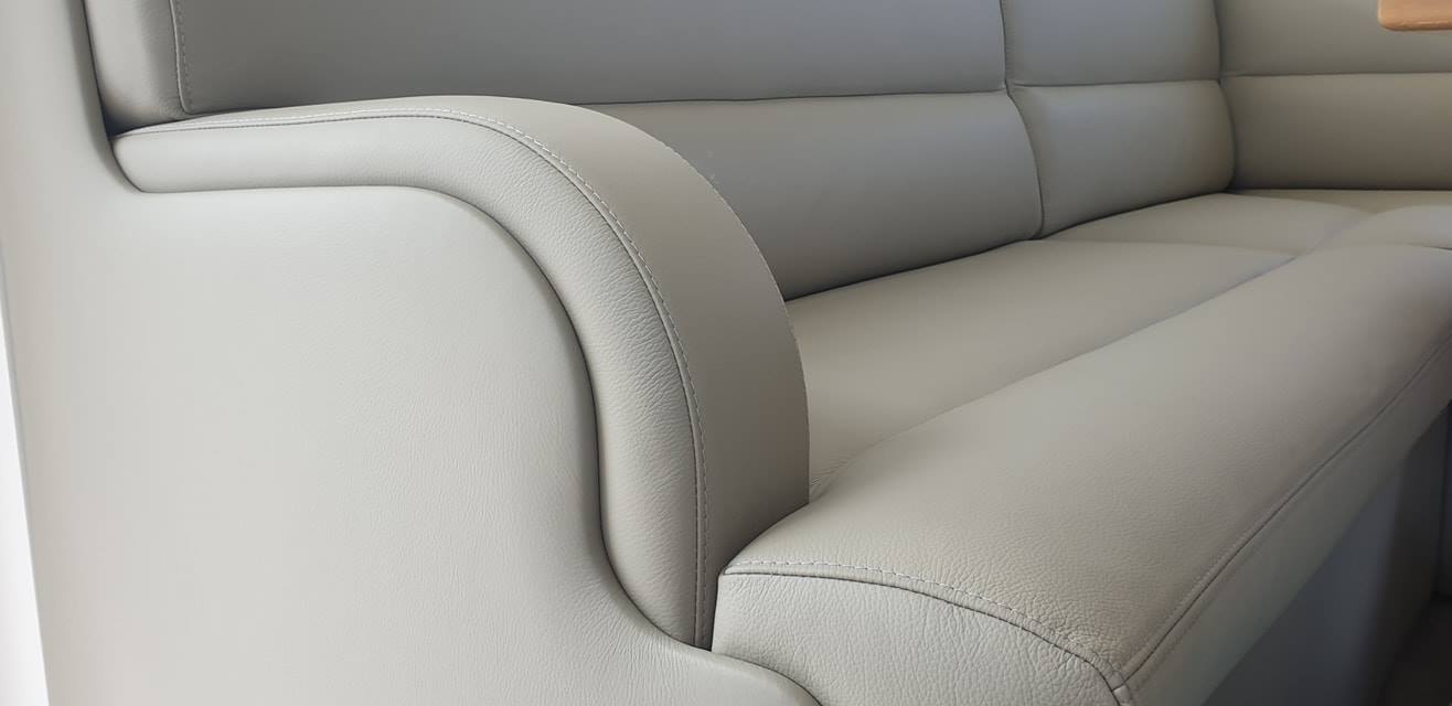 A Close Up of the Arm of a White Leather Couch — Coastal Coverings In Smithfield, QLD