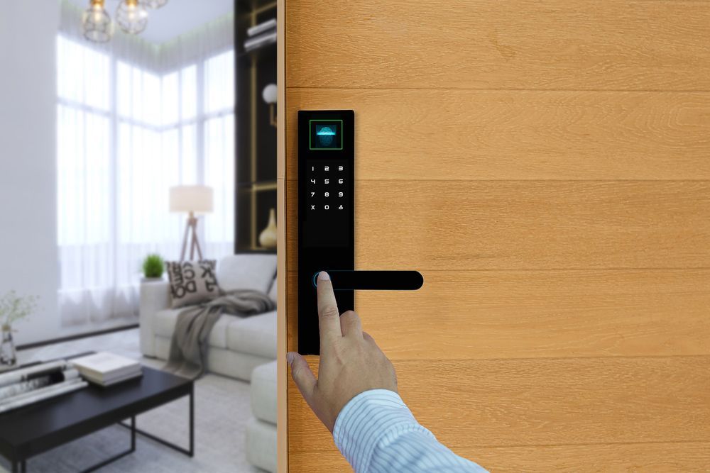 A person is using a smart door lock to open a wooden door in a living room.