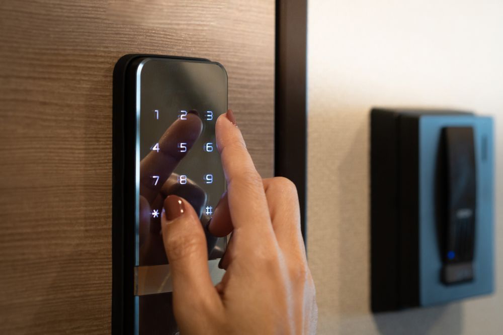 A person is pressing a button on a digital door lock.