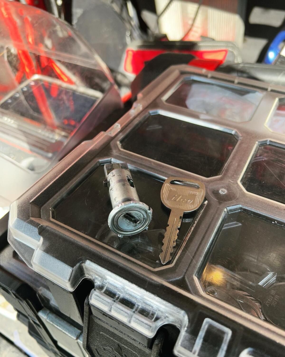 A key is sitting on top of a plastic container.