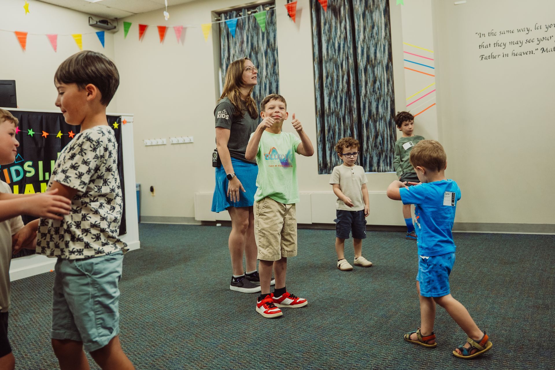 A group of children are playing with plastic cups on the floor