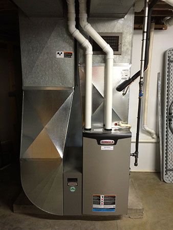 A heating and cooling system is installed in a basement.