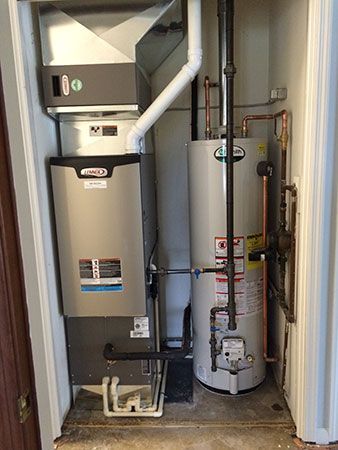 A room with a water heater , air conditioner , and furnace.