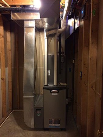A basement with a furnace and air conditioner in it.