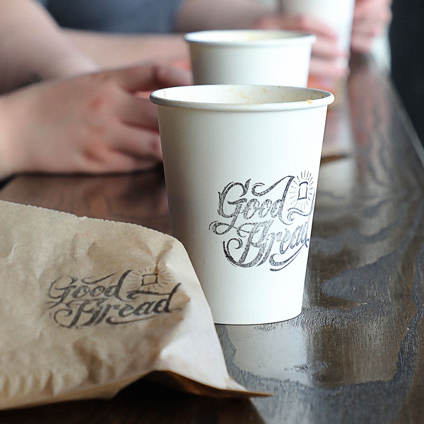 A paper cup that says good bread on it