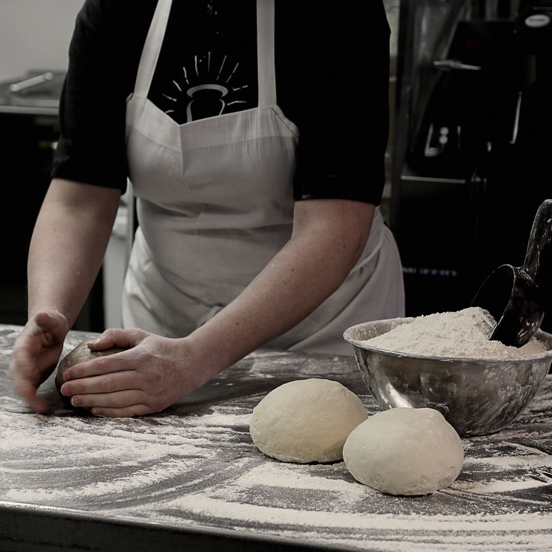 a man rolling dough