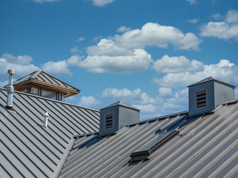 Photograph showing metal Roofing contractors at work